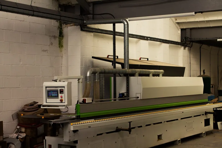 CNC edge bander applying a durable ABS edge at the Superio workshop